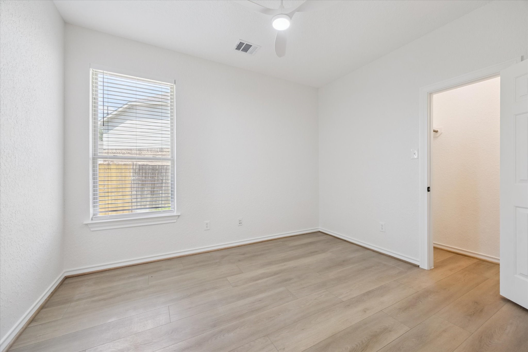 26110 Pointer Ridge Lane Katy, TX 77494 - Photo 20 of 25 an empty room with wooden floor and windows