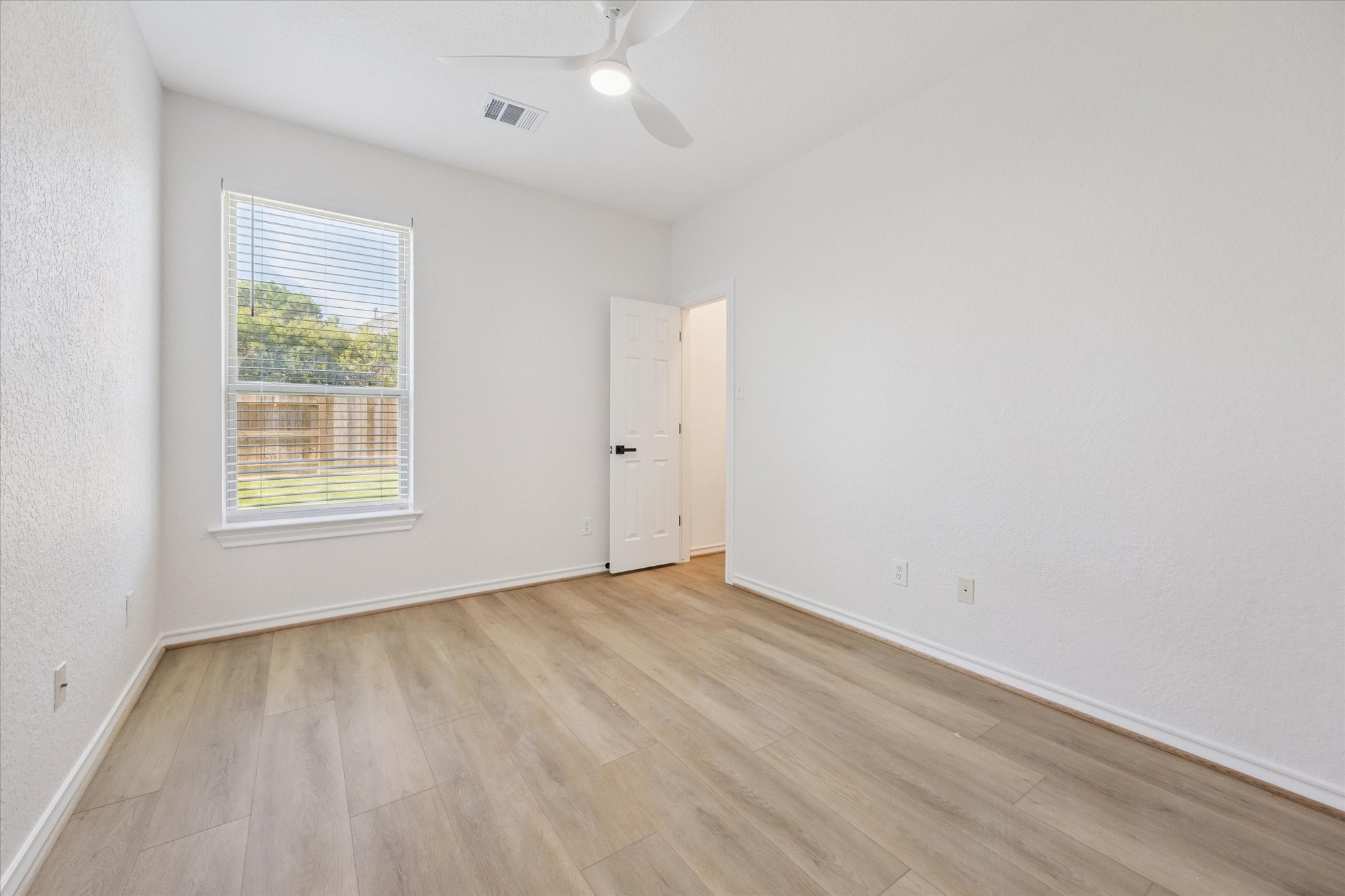 26110 Pointer Ridge Lane Katy, TX 77494 - Photo 21 of 25 an empty room with wooden floor and windows