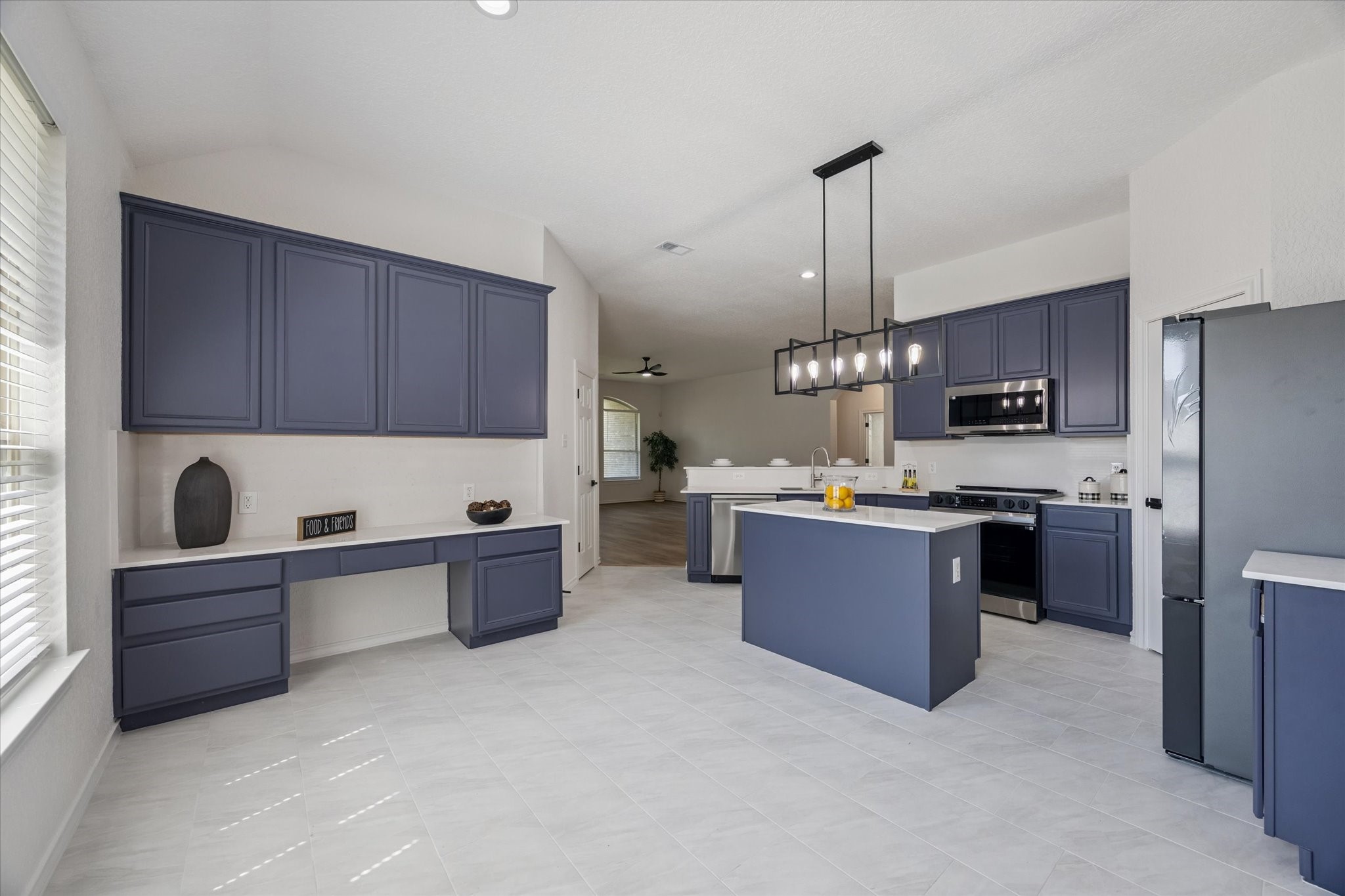 26110 Pointer Ridge Lane Katy, TX 77494 - Photo 8 of 25 a kitchen with kitchen island a wooden floor stainless steel appliances and cabinets