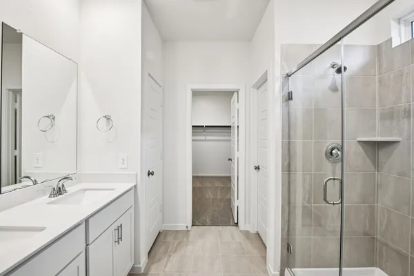 a bathroom with a granite countertop sink a shower and a mirror