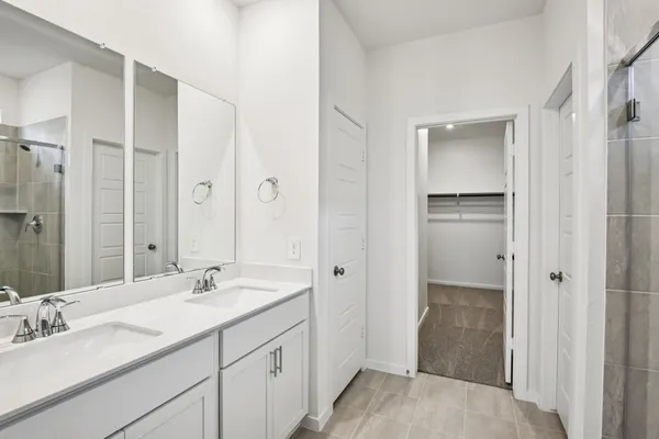 a bathroom with a sink double vanity and a mirror