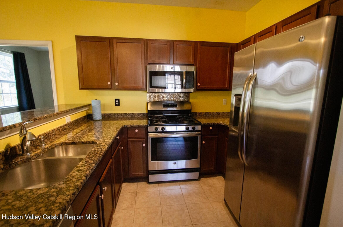 402 Commons Lane Saugerties, NY 12477 - Photo 19 of 29 a kitchen with a refrigerator and a sink