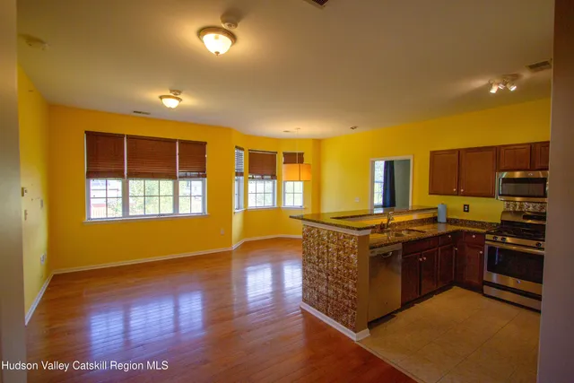 a kitchen with stainless steel appliances granite countertop a stove and a refrigerator