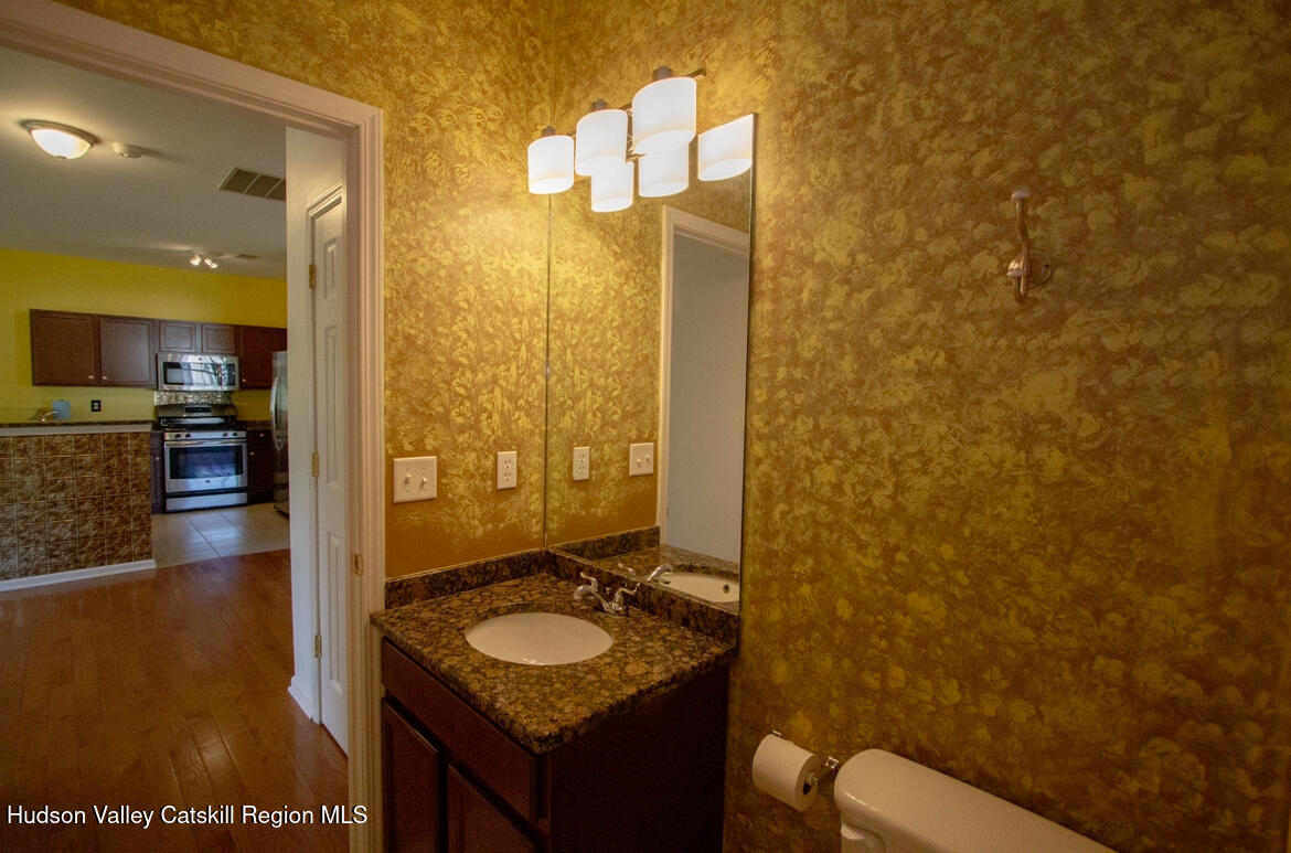 402 Commons Lane Saugerties, NY 12477 - Photo 22 of 29 a bathroom with a granite countertop sink and a mirror