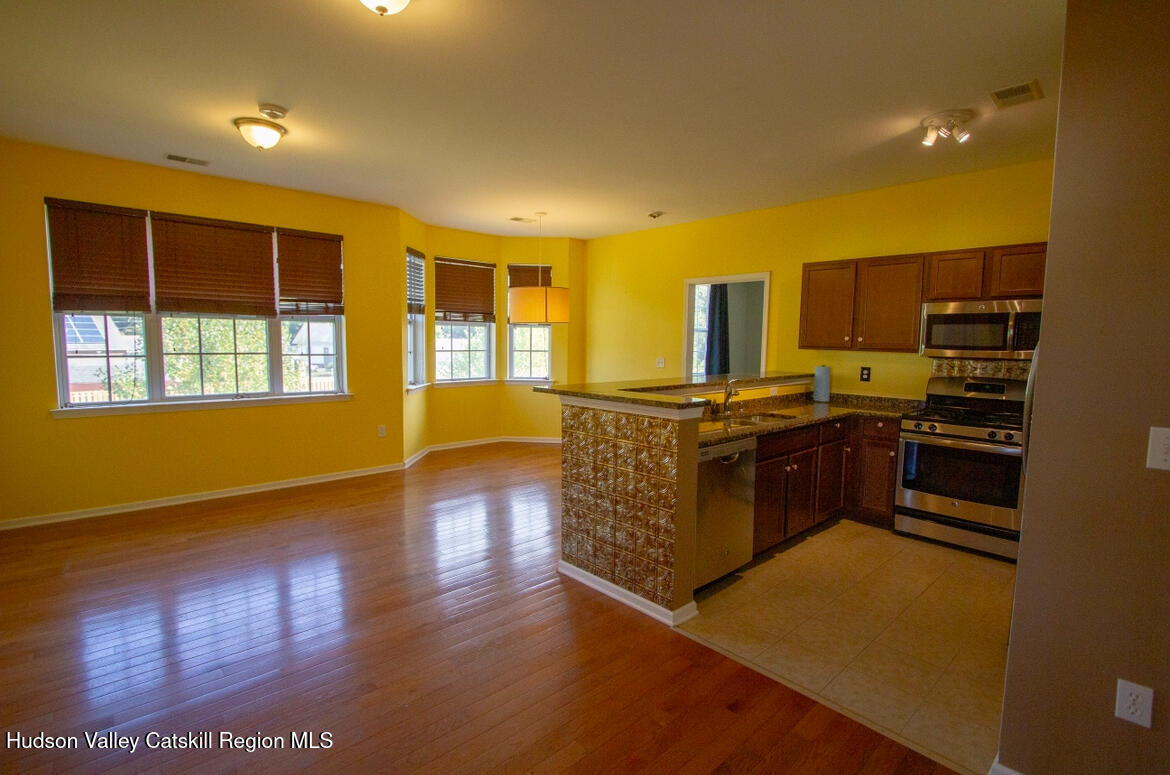 402 Commons Lane Saugerties, NY 12477 - Photo 4 of 29 a kitchen with stainless steel appliances granite countertop a stove a sink and a refrigerator