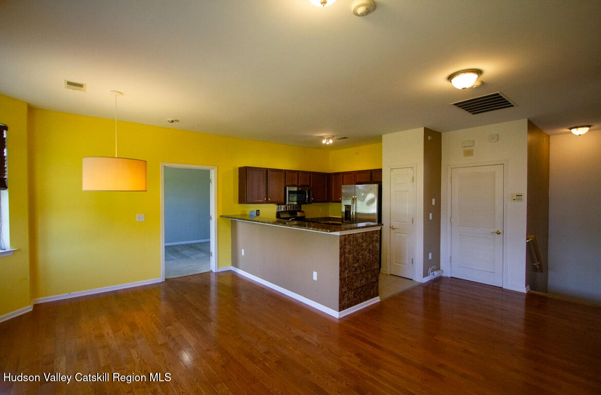 402 Commons Lane Saugerties, NY 12477 - Photo 6 of 29 a kitchen with a refrigerator and a stove top oven