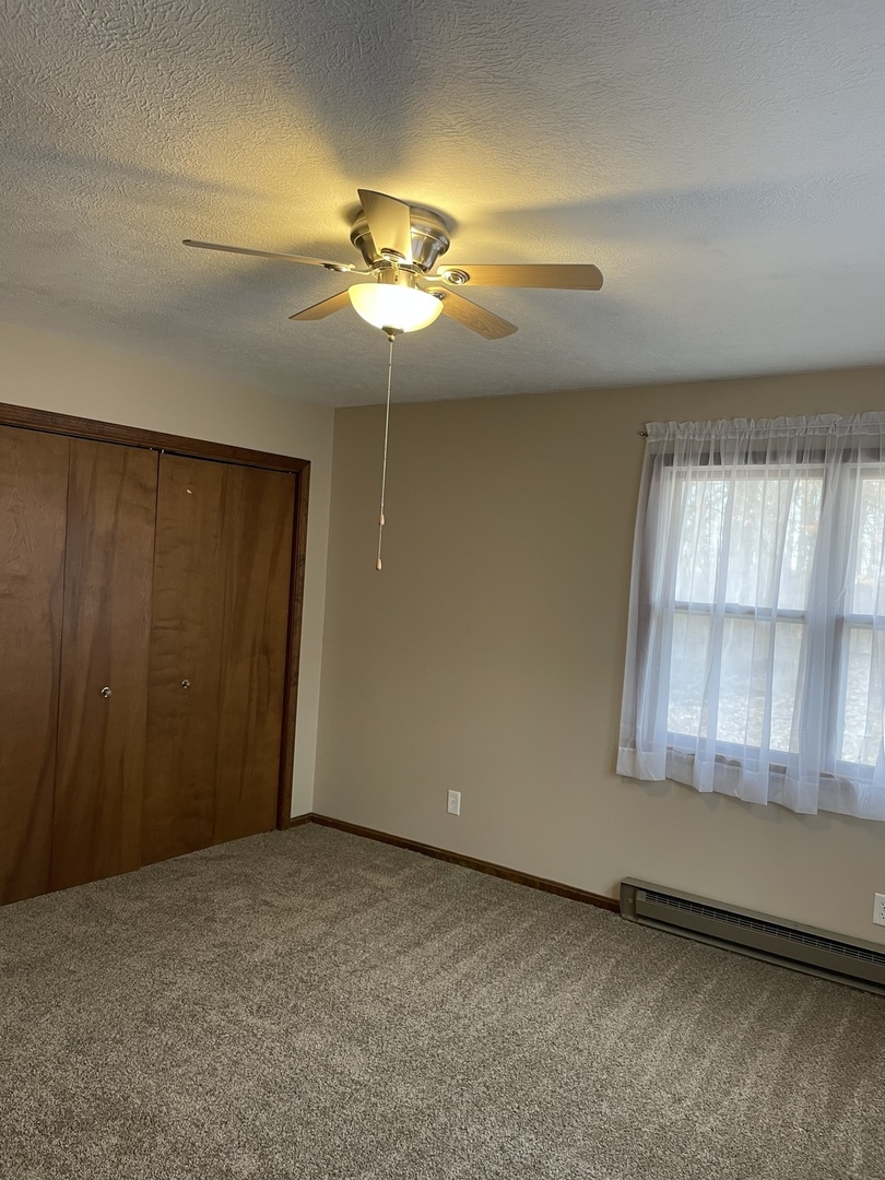 5650 West Bluff Road Morris, IL 60450 - Photo 25 of 53 an empty room with windows and chandelier fan