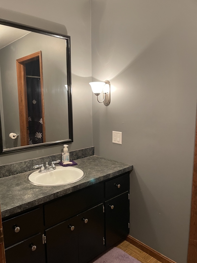 5650 West Bluff Road Morris, IL 60450 - Photo 29 of 53 a bathroom with a granite countertop sink and a mirror