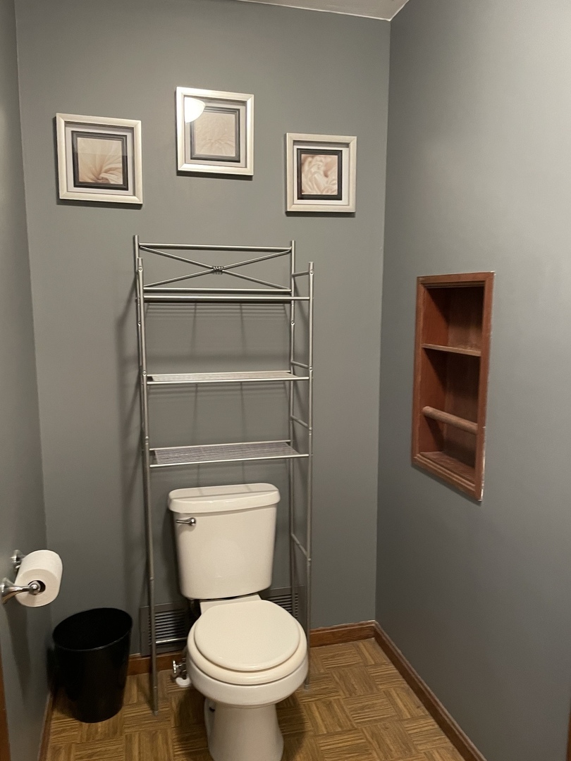 5650 West Bluff Road Morris, IL 60450 - Photo 31 of 53 a white toilet sitting next to a bathroom sink