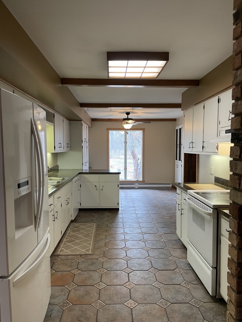 5650 West Bluff Road Morris, IL 60450 - Photo 10 of 53 a large kitchen with a stove a refrigerator and a sink