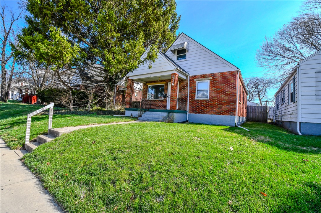 816 South Smithville Road Dayton, OH 45403 - Photo 2 of 33 This charming home offers a lovely front yard and classic brick exterior.