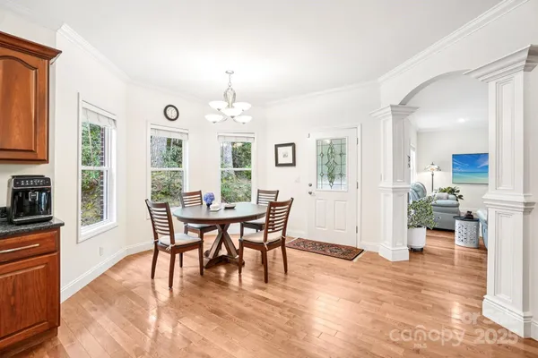 a view of a dining room with furniture window and wooden floor