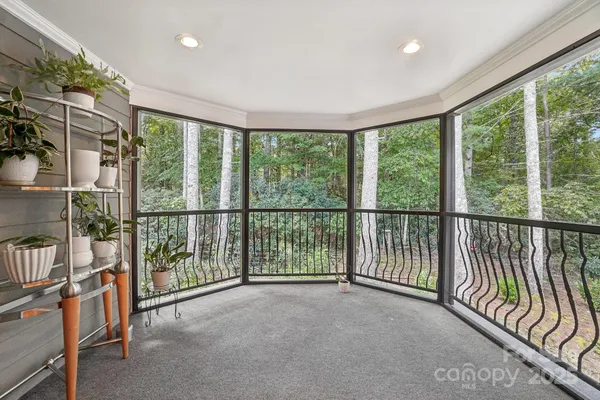 a view of a room with wooden floor and iron stairs