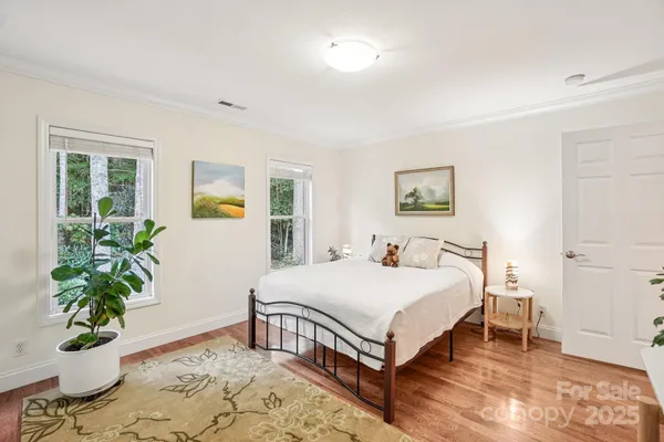 a bedroom with a bed and a potted plant