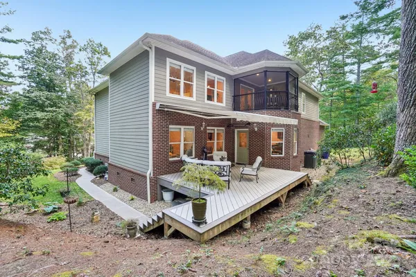 a view of a house with backyard and sitting area