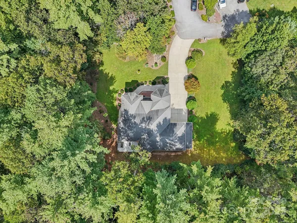 an aerial view of a house with a yard