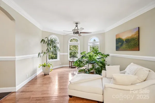 a living room with furniture and a chandelier