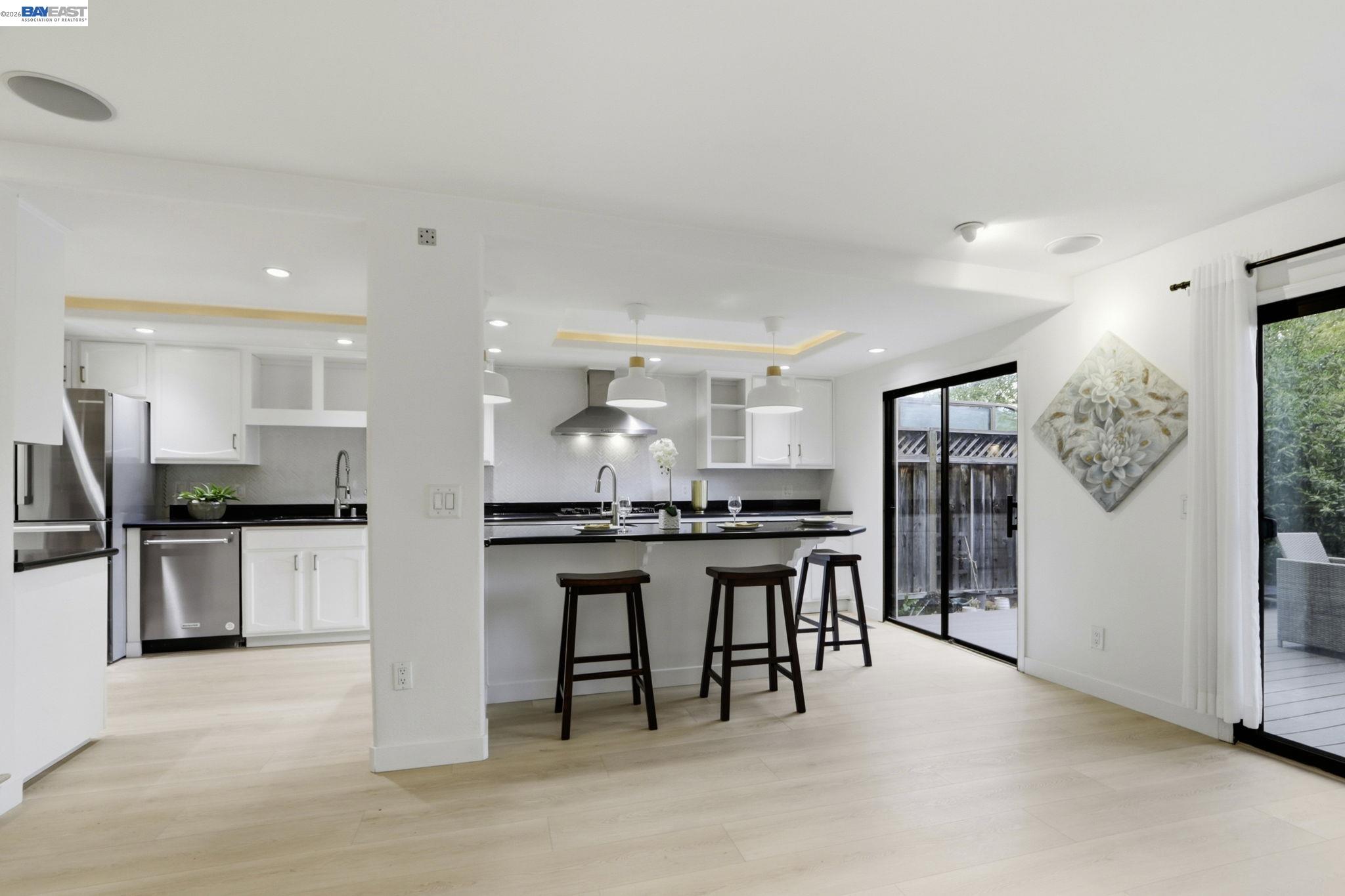 60 Jacklin Place Milpitas, CA 95035 - Photo 12 of 45 a kitchen with stainless steel appliances kitchen island granite countertop a table and chairs in it