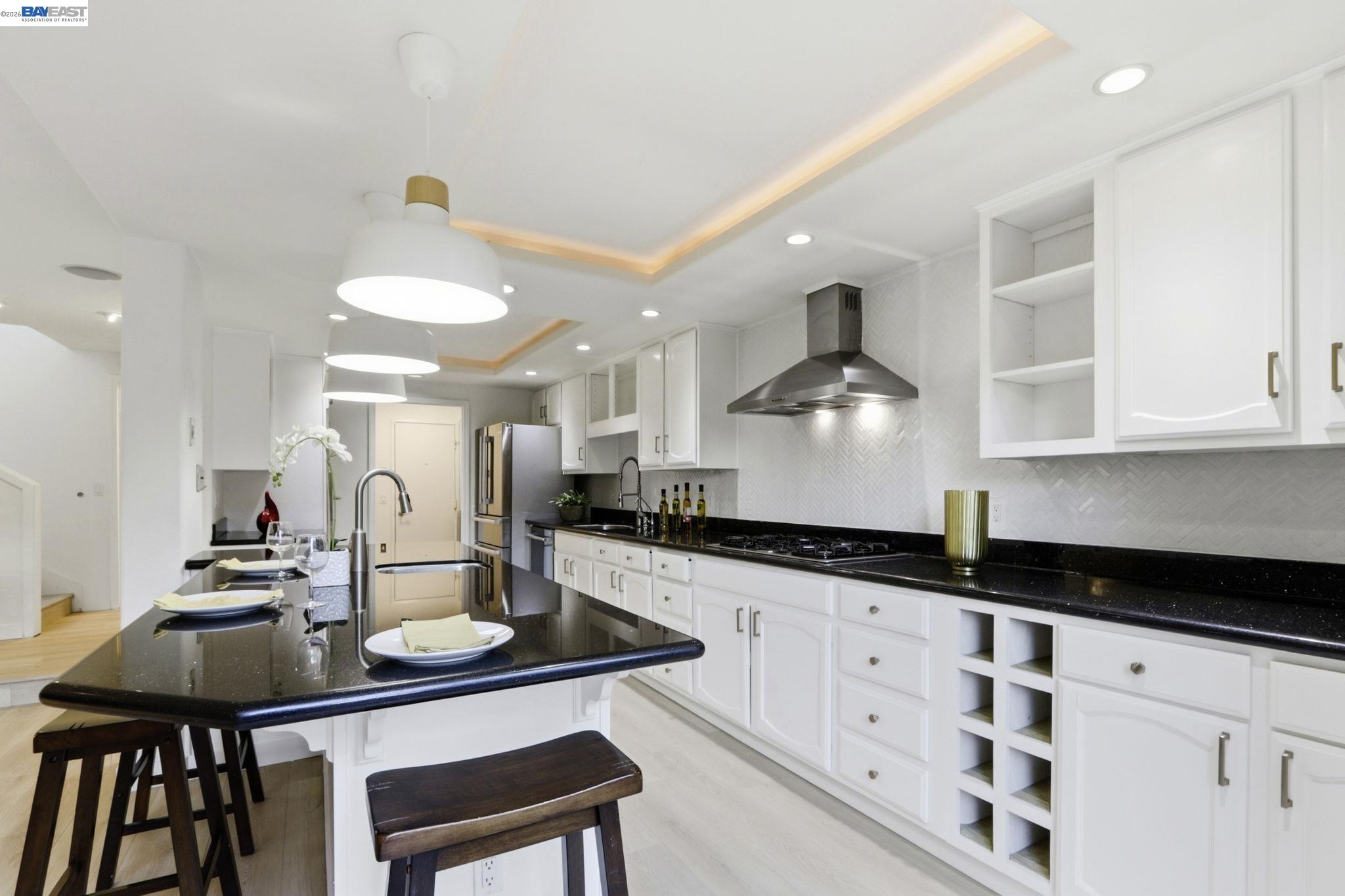 60 Jacklin Place Milpitas, CA 95035 - Photo 14 of 45 a kitchen with granite countertop a table chairs stove and cabinets