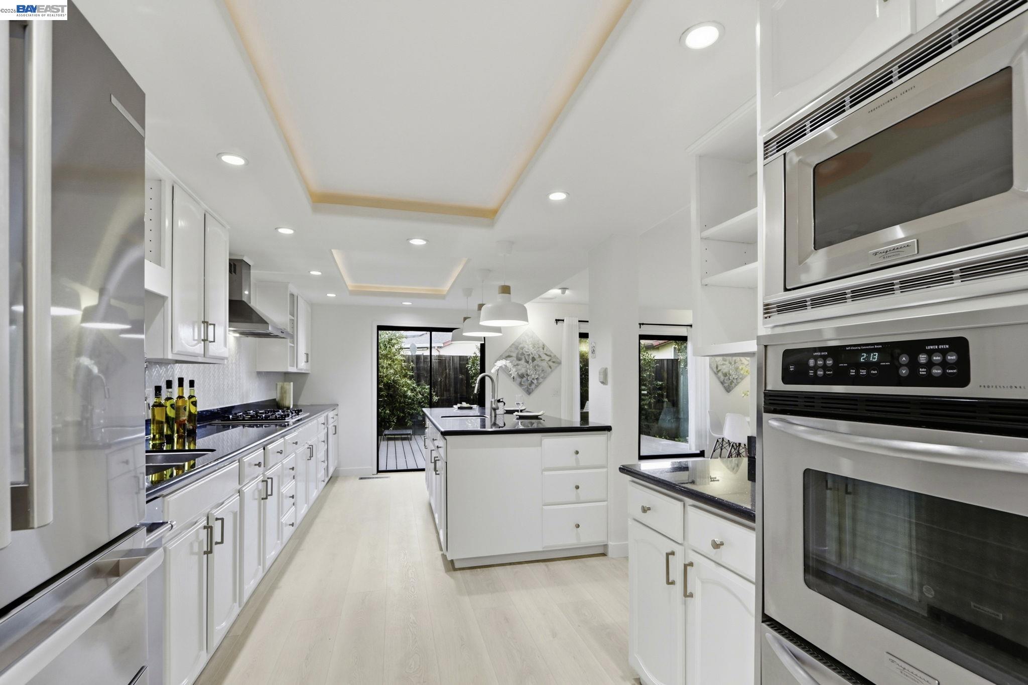 60 Jacklin Place Milpitas, CA 95035 - Photo 16 of 45 a kitchen with stainless steel appliances kitchen island granite countertop a stove a sink and a microwave