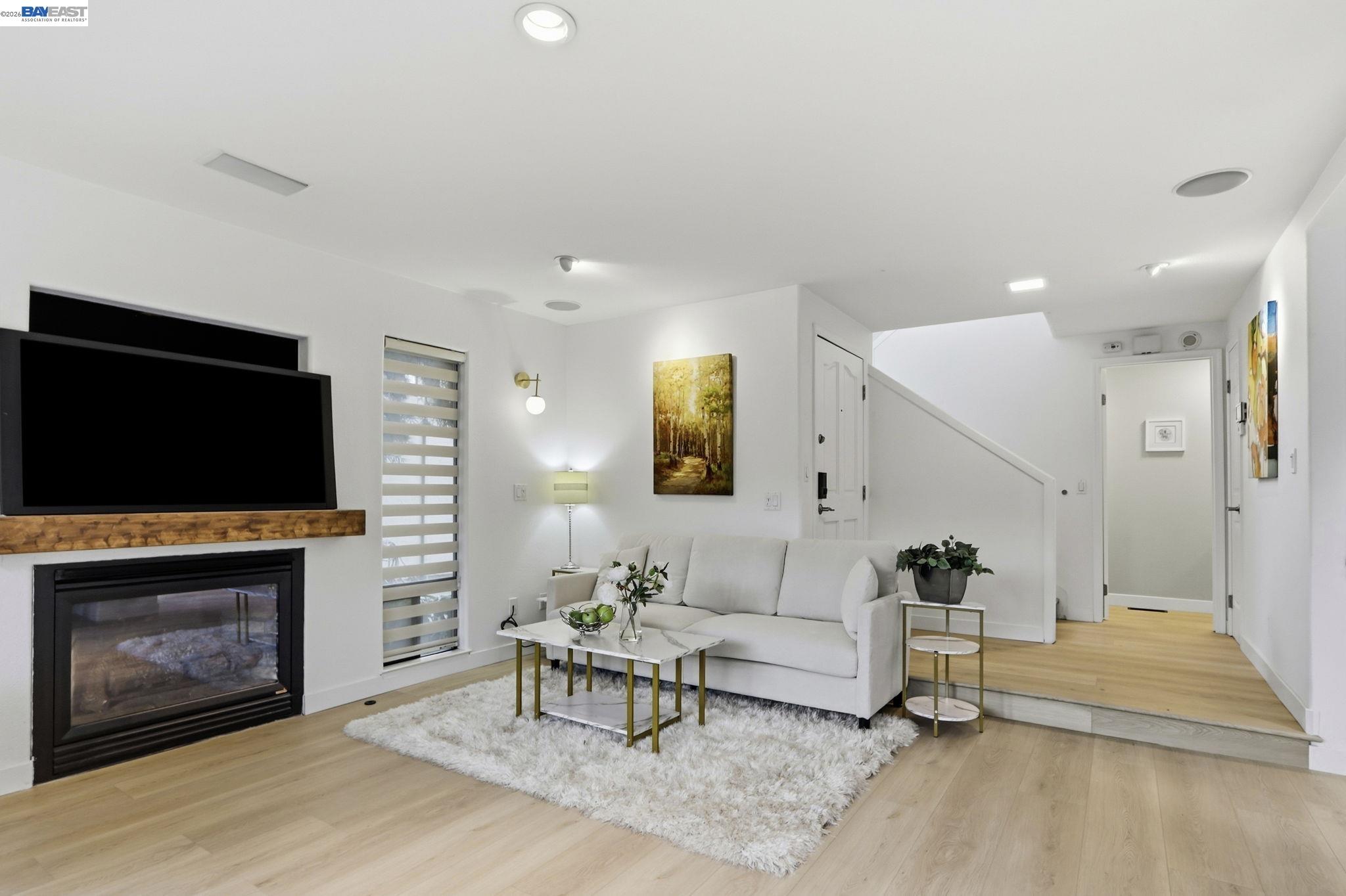 60 Jacklin Place Milpitas, CA 95035 - Photo 2 of 45 a living room with furniture a flat screen tv and a fireplace