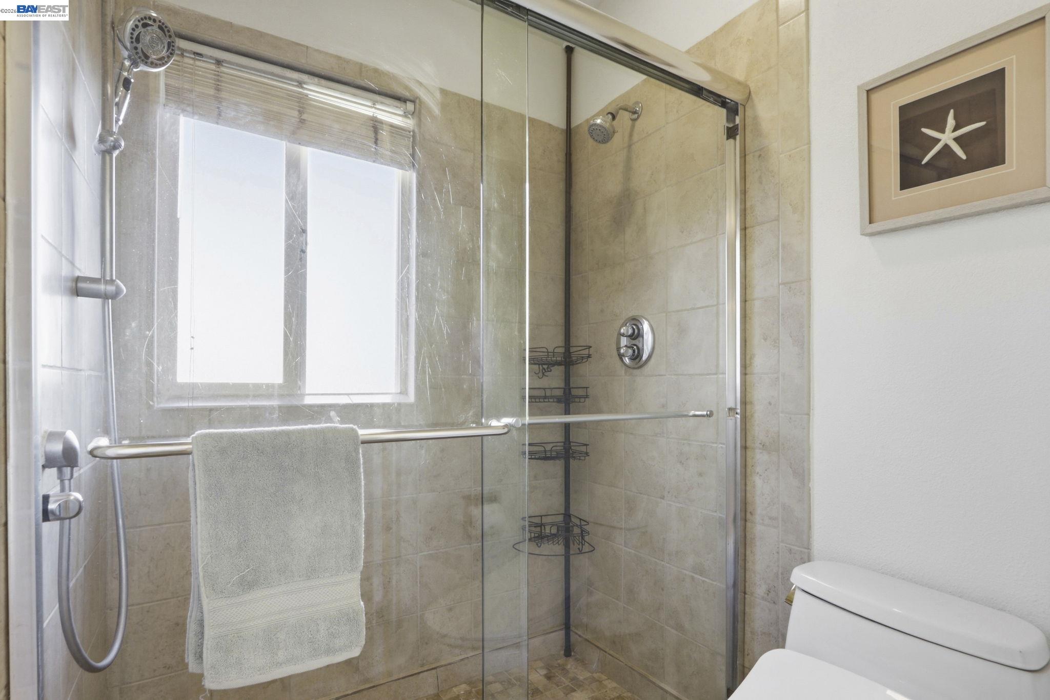 60 Jacklin Place Milpitas, CA 95035 - Photo 30 of 45 a bathroom with a glass shower door