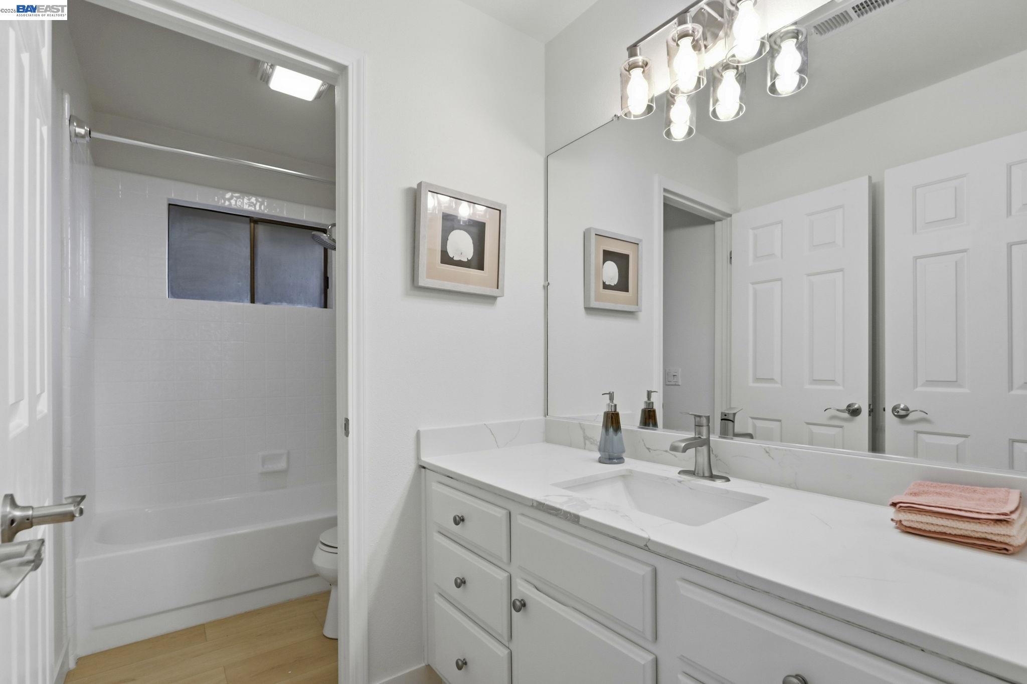 60 Jacklin Place Milpitas, CA 95035 - Photo 34 of 45 a bathroom with a sink a large mirror and a bathtub