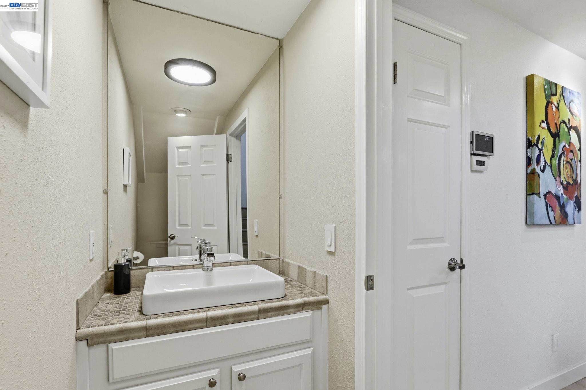 60 Jacklin Place Milpitas, CA 95035 - Photo 36 of 45 a bathroom with a sink and a mirror