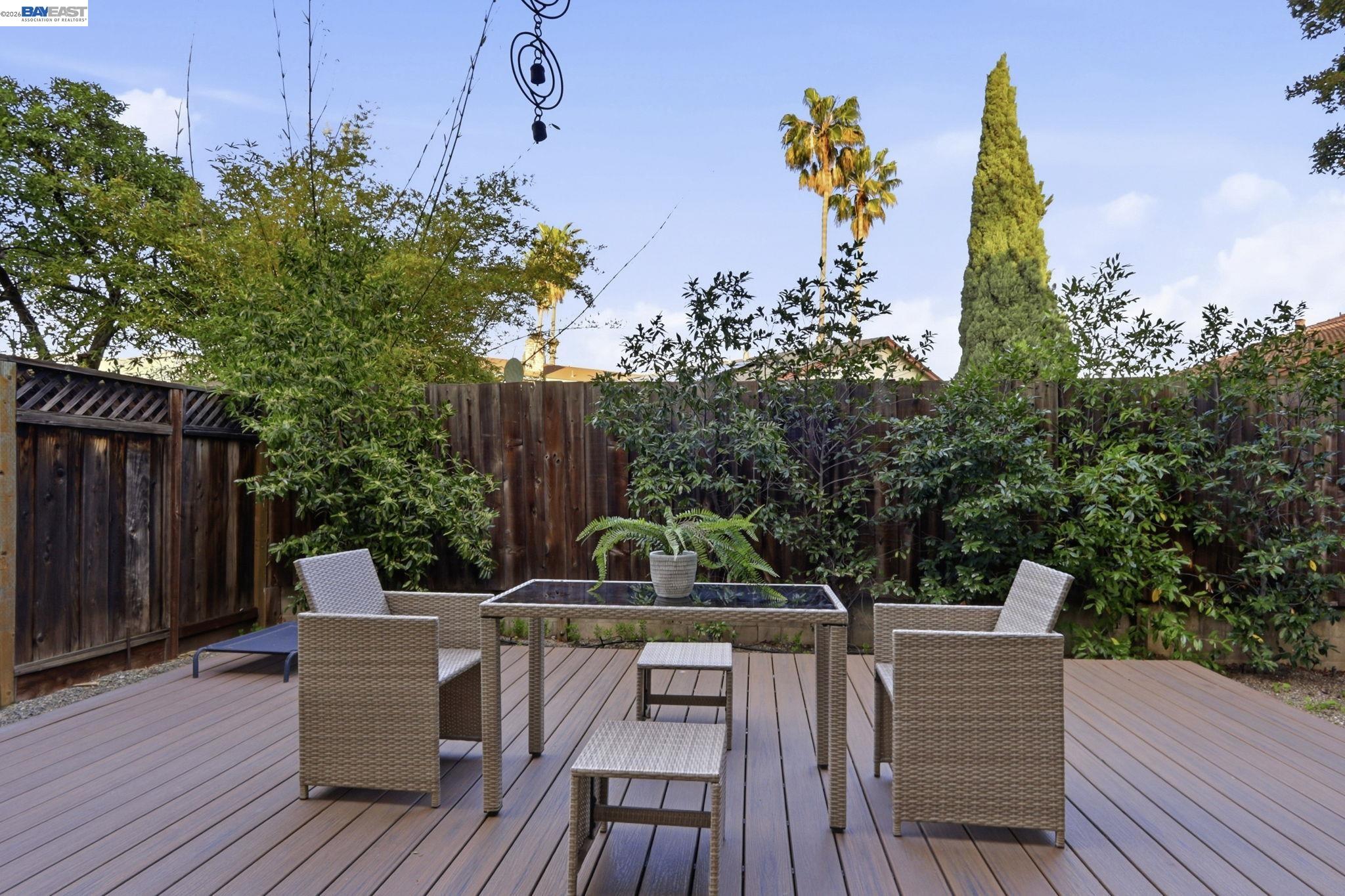 60 Jacklin Place Milpitas, CA 95035 - Photo 45 of 45 a view of a patio with couches and table and chairs with wooden floor and fence