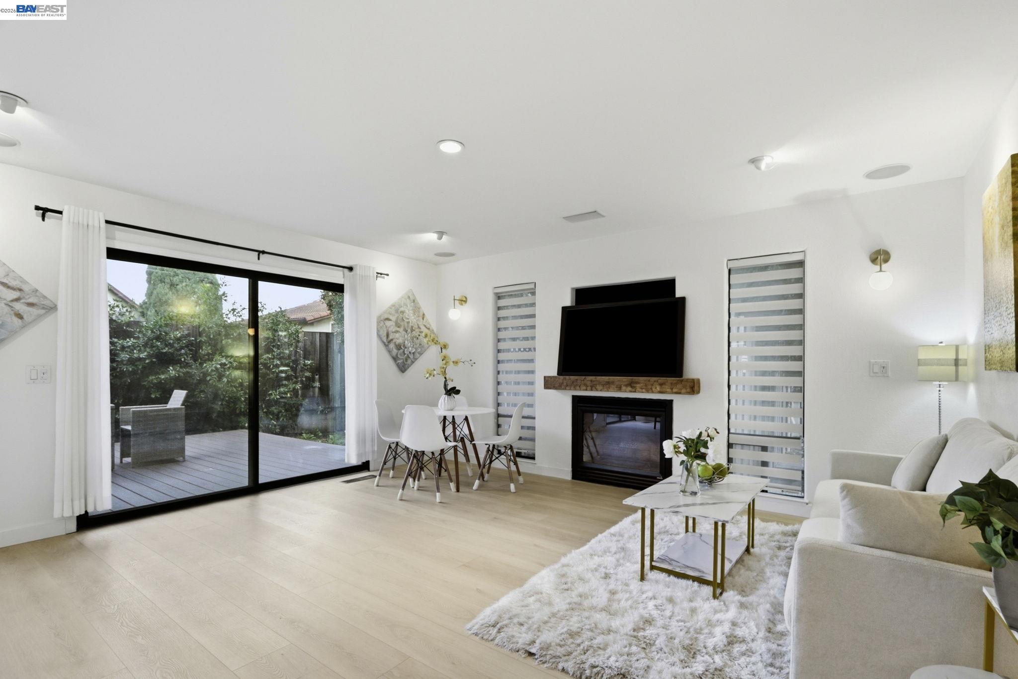60 Jacklin Place Milpitas, CA 95035 - Photo 7 of 45 a living room with furniture a flat screen tv and a fireplace