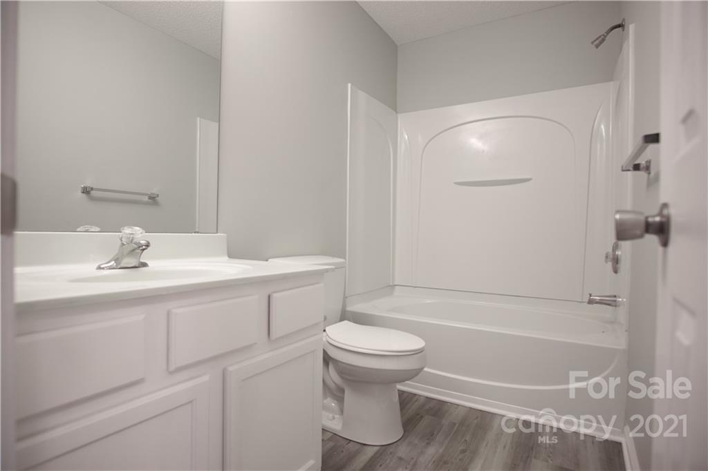 3235 Blythe Ridge Court Charlotte, NC 28213 - Photo 12 of 14 a bathroom with a sink toilet and shower