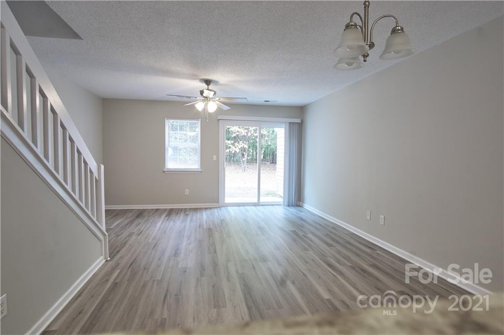 3235 Blythe Ridge Court Charlotte, NC 28213 - Photo 3 of 14 a view of an empty room with wooden floor and a window