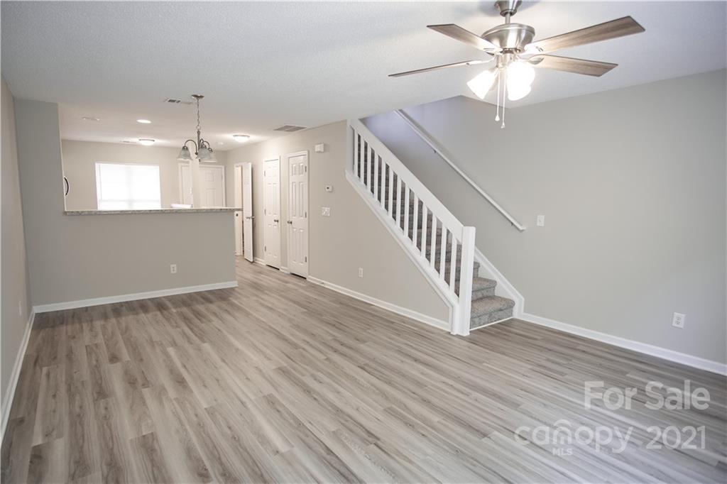 3235 Blythe Ridge Court Charlotte, NC 28213 - Photo 4 of 14 a view of an empty room with wooden floor and a ceiling fan