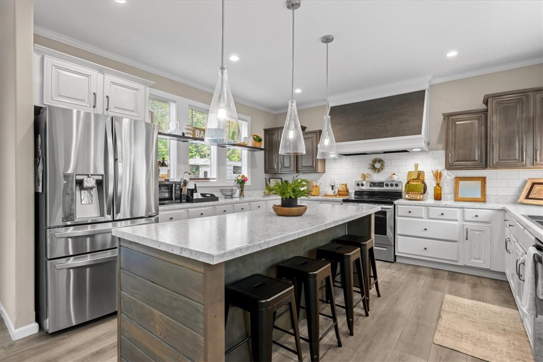 116 Parkview Road Iva, SC 29655 - Photo 7 of 44 An inviting kitchen features a large island, sleek appliances, and elegant pendant lighting.