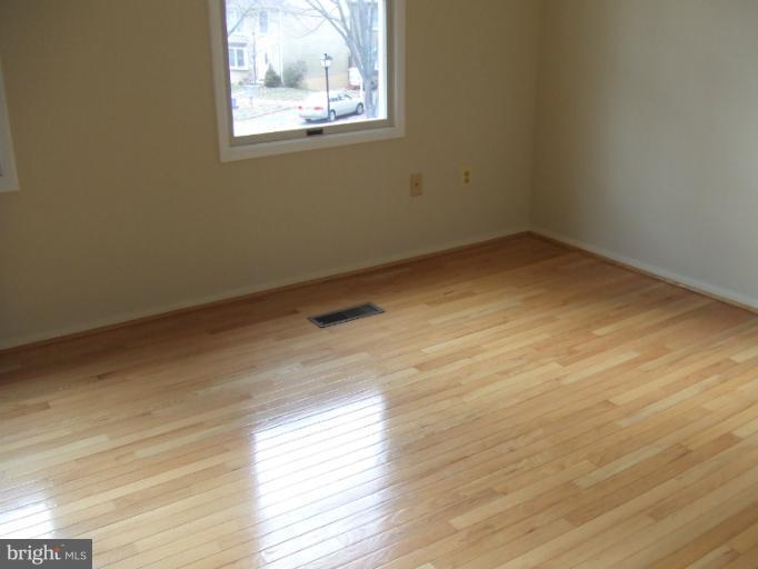 23 Cross Ridge Court Germantown, MD 20874 - Photo 11 of 19 a view of empty room with wooden floor and fan