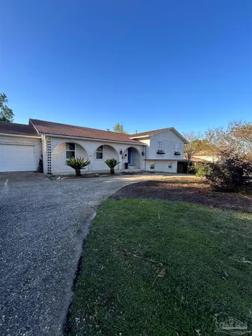 a backyard of a house with table and chairs