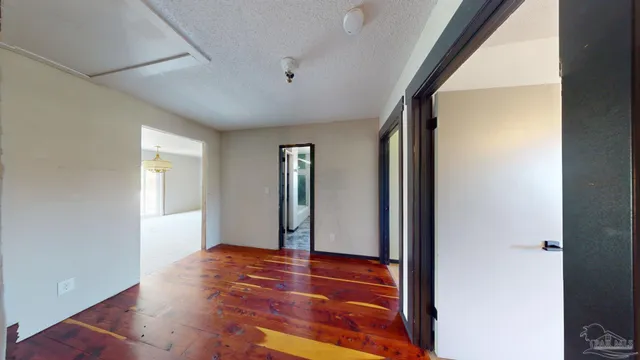 a view of a room with wooden floor and white walls