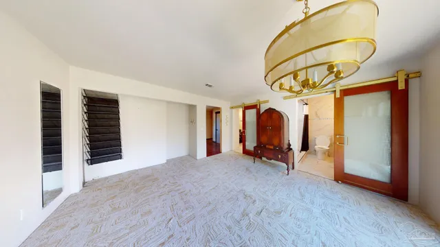 a view of a room with wooden floor and furniture