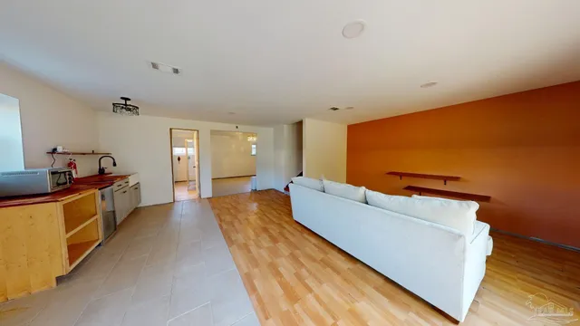 an empty room with windows and fireplace