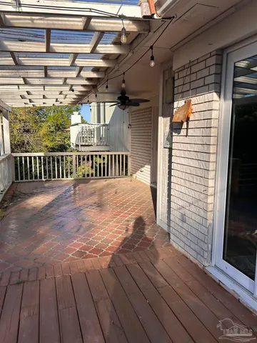 a white vase with flowers sitting on a table