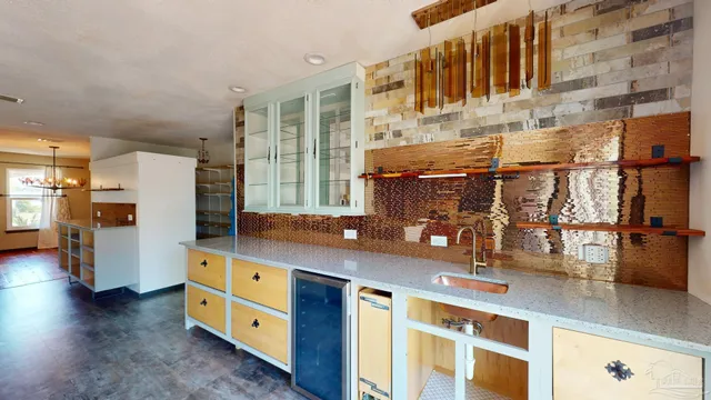 a kitchen with stainless steel appliances granite countertop a sink and a refrigerator