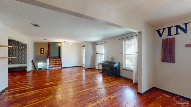 a hallway with a white kitchen countertops and wooden floor