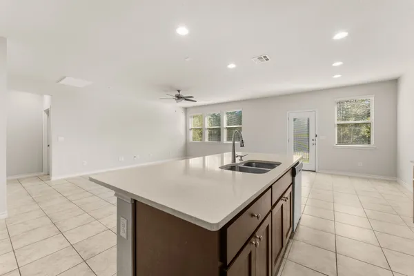 a kitchen that has a sink a stove and a table in it