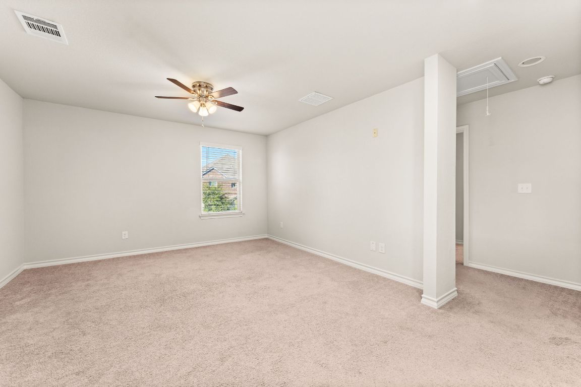 740 Aliso Trail Leander, TX 78641 - Photo 21 of 35 an empty room with windows and ceiling fan