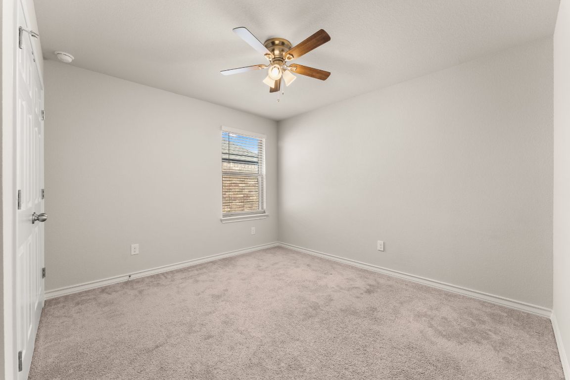740 Aliso Trail Leander, TX 78641 - Photo 23 of 35 an empty room with windows and fan