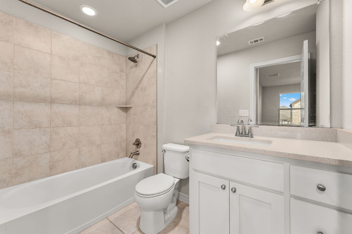 740 Aliso Trail Leander, TX 78641 - Photo 25 of 35 a bathroom with a sink a toilet and shower