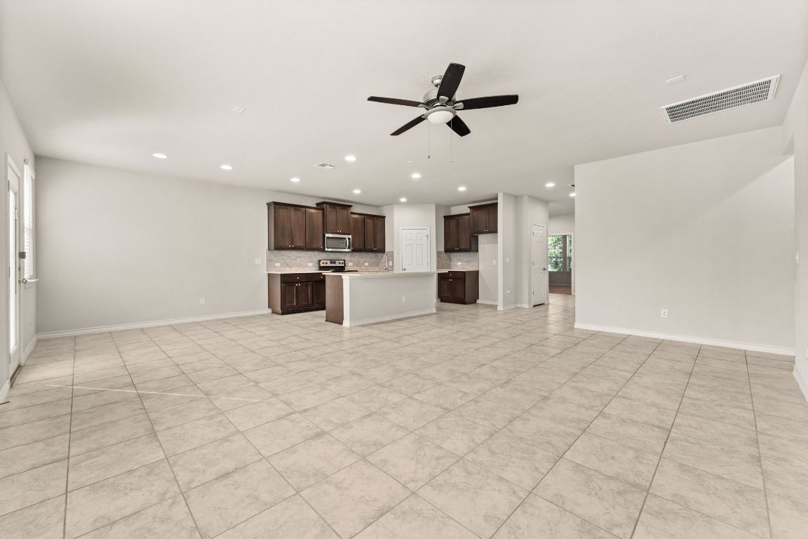 740 Aliso Trail Leander, TX 78641 - Photo 6 of 35 a view of a kitchen with a dishwasher and a refrigerator