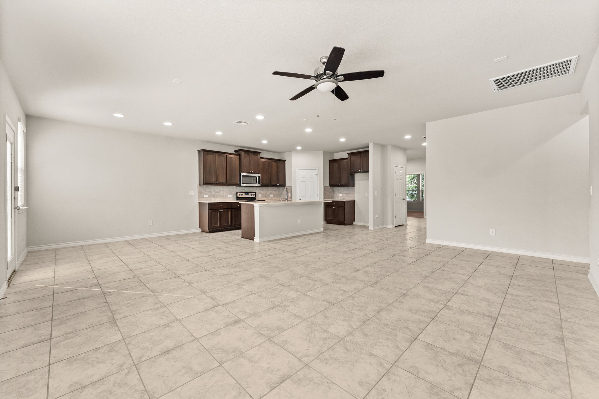 740 Aliso Trail Leander, TX 78641 - Photo 7 of 35 Tile flooring offers durability in this high-traffic gathering space.