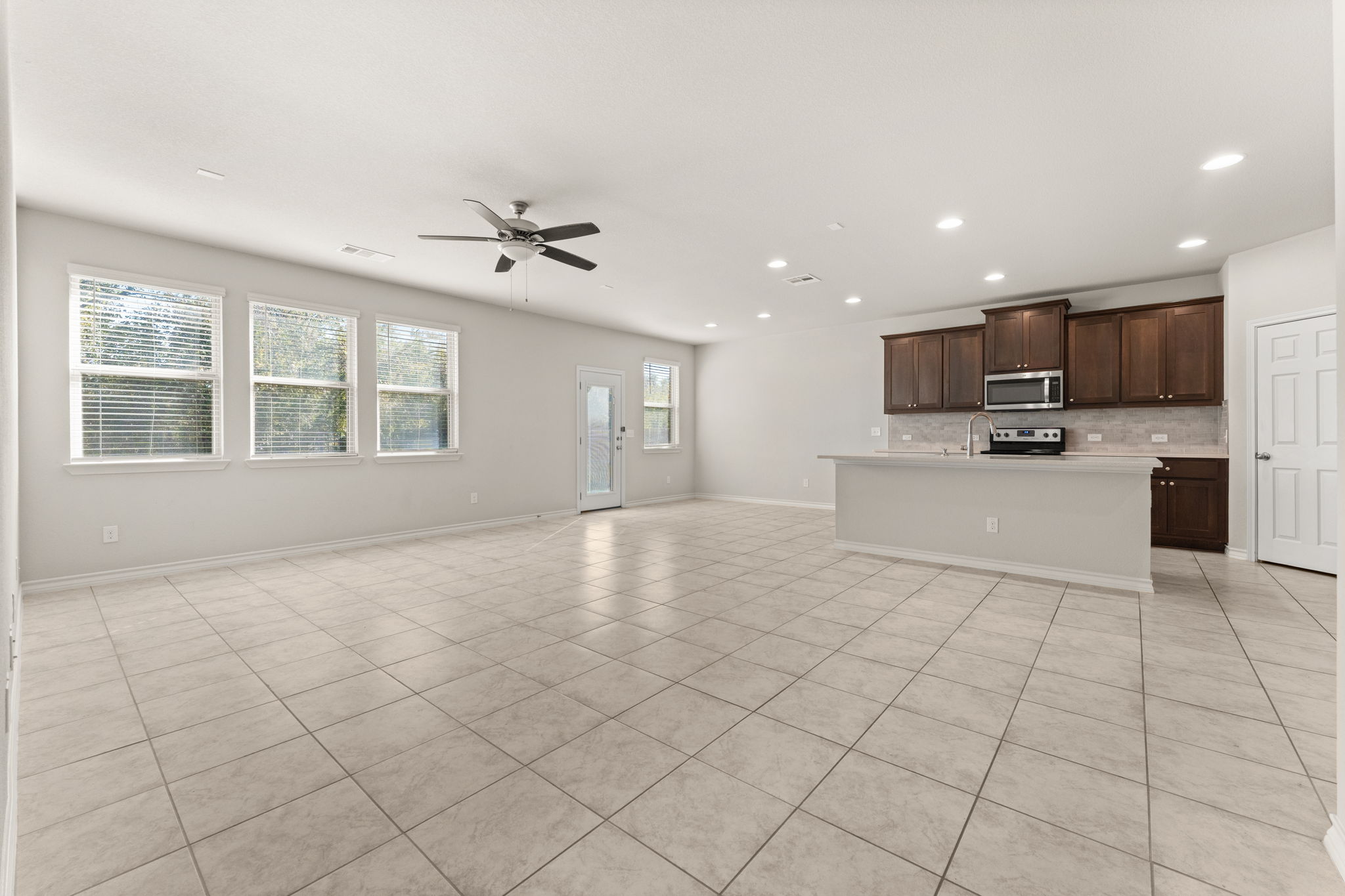 740 Aliso Trail Leander, TX 78641 - Photo 8 of 35 Large windows fill the space with natural light and frame greenbelt views.