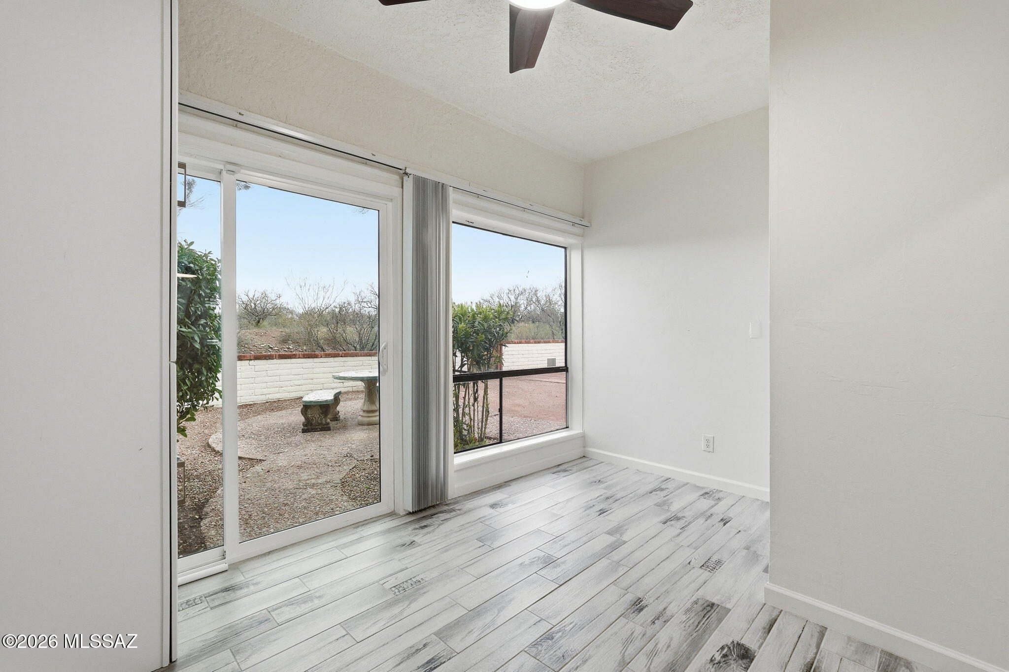 1183 Circulo Canario Rio Rico, AZ 85648 - Photo 16 of 31 an empty room with wooden floor and windows